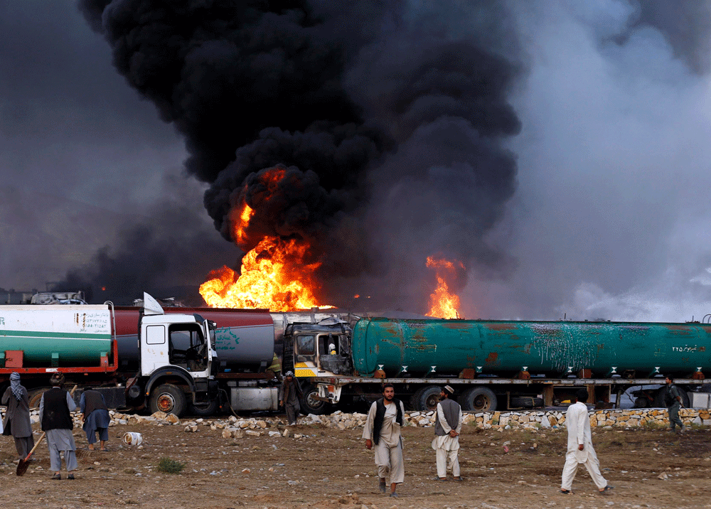 Smoke and flames rise from fuel trucks after an overnight attack by the Taliban on the outskirts of Kabul / Reuters Photo