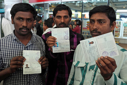 Indians from Iraq display their passports to the media upon arrival at the airport in Hyderabad. AP photo