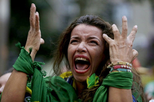 A Brazil soccer fan screams as Germany defeats her team 7-1 in a semifinal World Cup match as she watches the game on a live telecast in Belo Horizonte, Brazil, Tuesday, July 8, 2014. AP photo