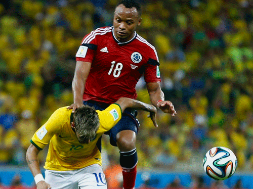 Brazil's Neymar (bottom) is fouled by Colombia's Camilo Zuniga during their 2014 World Cup quarter-finals at the Castelao arena in Fortaleza July 4, 2014. REUTERS