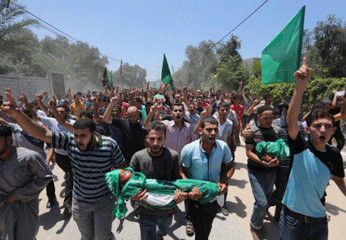 Palestinians carry the body of 3-year-old Mohammed Mnassrah during his funeral in the Maghazi refugee camp, central Gaza Strip. AP photo