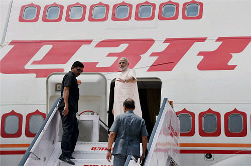 Prime Minister Narendra Modi waves as he leaves for Brazil to attend the five-nation BRICS summit, in New Delhi on Sunday. PTI Photo