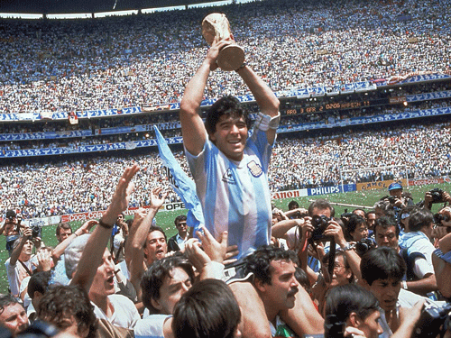 In this June 29, 1986, file photo, Diego Maradona, holds up the trophy, after Argentina beat West Germany 3-2 in their World Cup soccer final match, at the Atzeca Stadium, in Mexico City. On Sunday, July 13, 2014, Germany and Argentina will face each other again in the final of the 2014 soccer World Cup. (AP Photo)