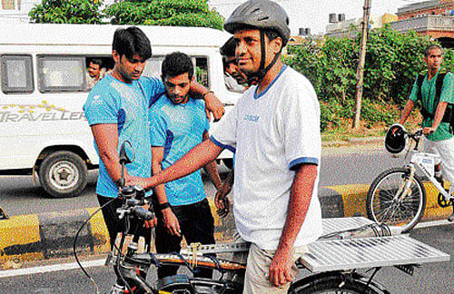 Pedalling a message:  Ajai Tirumali with his solar cycle.  DH PHOTO
