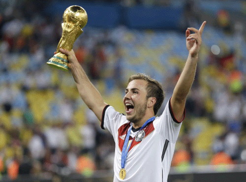 Germany's Mario Goetze, who scored the winning goal, holds the World Cup trophy following their 1-0 victory over Argentina after the World Cup final soccer match between Germany and Argentina at the Maracana Stadium in Rio de Janeiro, Brazil. AP photo