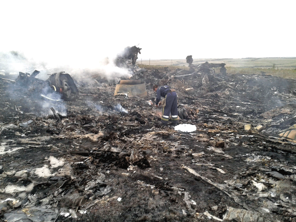 Emergencies Ministry members work at the site of a Malaysia Airlines Boeing 777 plane crash in the settlement of Grabovo in the Donetsk region, July 17, 2014. The Malaysian airliner was shot down over eastern Ukraine by pro-Russian militants on Thursday, killing all 295 people aboard, a Ukrainian interior ministry official said. REUTERS