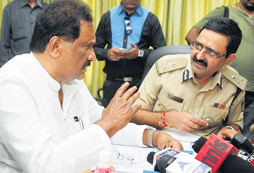 Tough talk: Home Minister K J George and Police Commissioner of Bangalore Raghavendra Auradkar at a  media briefing in Bangalore on Friday. dh photo