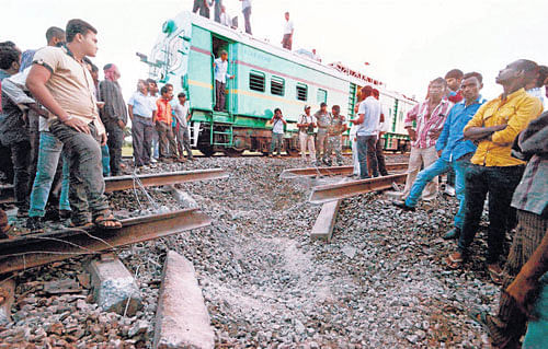 People assemble near the railway track that was blown up by Maoists near the Rafiganj railway station in Bihar late on Tuesday night. PTI photo