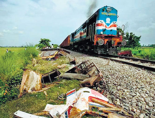 The Nanded-Kacheguda passenger train on the track right after it rammed into a school bus, the mangled  remains of which are seen at the bottom. DH photo