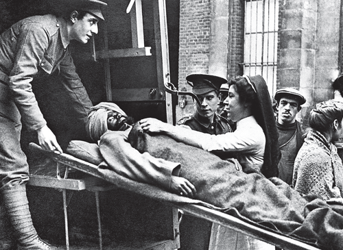 An Indian soldier wounded in World War I being attended to.