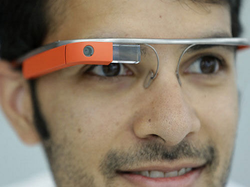 Lenovo is developing a wearable smart glass similar to Google Glass with an external battery to be worn on the neck. AP photo