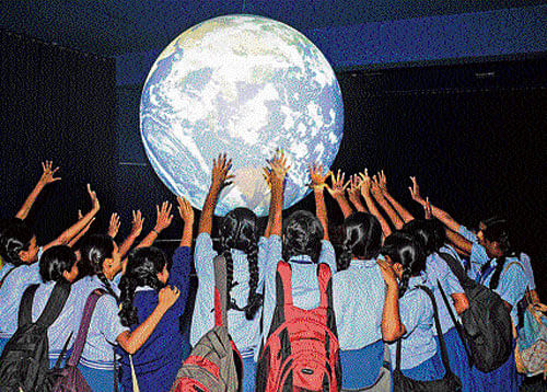 FEELING UNIVERSE Students experience 'Science on a Sphere' at the Visvesvaraya Industrial and Technological Museum  on Monday. DH photo
