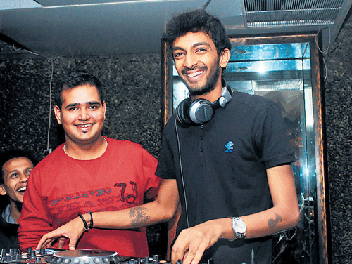 Riaz (in red) coordinating an event with DJ Varun. DH Metrolife print