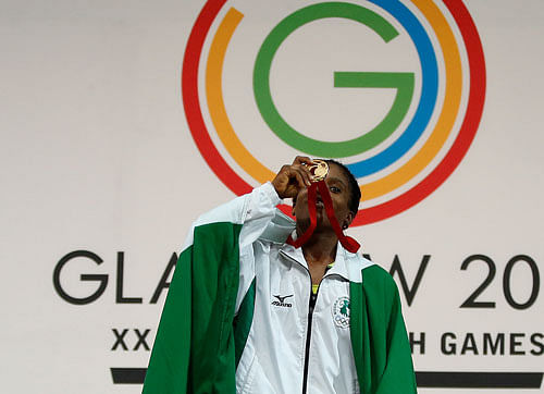 file photo of Chika Amalaha of Nigeria, as he kisses her gold medal for winning the women's 53 kg weightlifting competition at the Commonwealth Games Glasgow 2014, in Glasgow, Scotlanddid. The Nigerian weightlifting gold medalist Chika Amalaha has failed a doping test at the Commonwealth Games and has been provisionally suspended from the games. Commonwealth Games Federation chief executive Mike Hooper said Tuesday July 29, 2014 that Amalaha tested positive for diuretics and masking agents after being tested on July 25. AP Photo