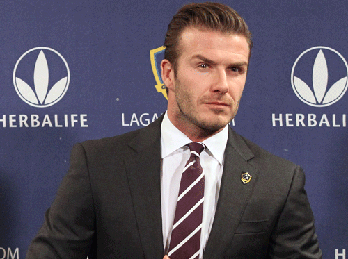 Former soccer star David Beckham has been voted the best male celebrity 'suit wearer' in a new poll. AP file photo