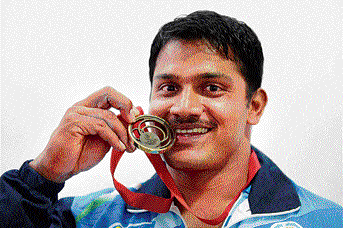 fine end Lifter Chandrakant Mail is all smiles after winning the 94kg bronze on Tuesday. pti