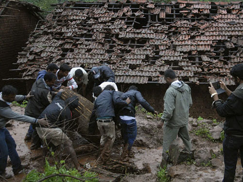 Rescue workers turned to life detectors and sniffer dogs in their effort to locate more survivors at the site of the landslide in Pune's Malingaon. Reuters file photo