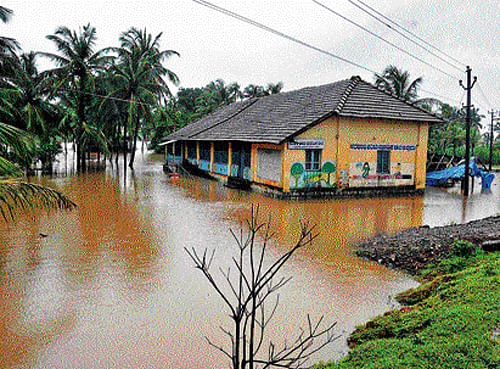 The Government Higher Primary School at Uppoor near Brahmavar inundated in the flood water after the region received heavy rains on Friday. DH photo