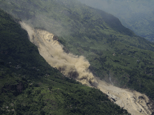 A landslide is seen in Sindhupalchowk district August 2, 2014. A massive landslide triggered by heavy rains in northeast Nepal on Saturday has killed at least eight people, injured 40 and buried dozens of homes, officials said.  Reuters photo