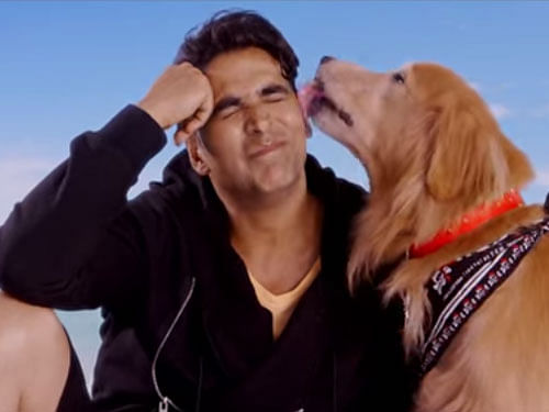 Superstar Akshay Kumar sent out a message that a pet is man's best friend, by posting a still from his upcoming film 'Entertainment', where he is shown smiling with a dog / Screen Shot