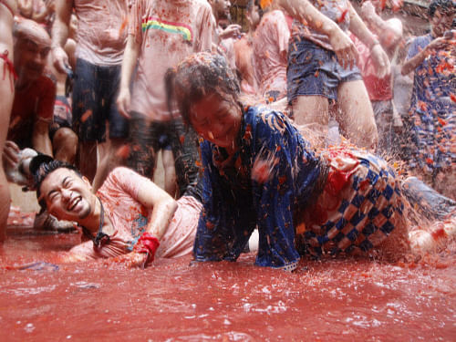 Youths here today celebrated 'La Tomatina' to mark the Friendship Day, perhaps unmindful of the fact that price of the commodity has soared to Rs 100 per kg in markets. AP photo. For representation purpose