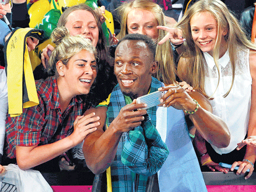 Usain Bolt takes a selfie with the fans after powering Jamaica to victory in the4x100Mrelay on Saturday. REUTERS
