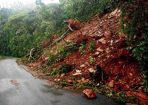 Ravaged by rain: Vehicular traffic was disrupted as earth caved in on the Kudremukh highway at Hosamakki near Kalasa in Chikmagalur district. People walk on a flooded pathway in Hampi. dh/kpn photos