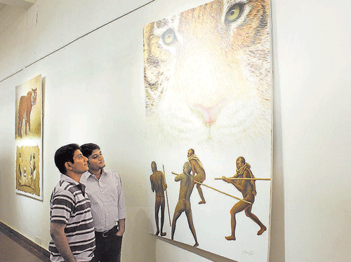 Visitors viewing the tiger themed paintings.