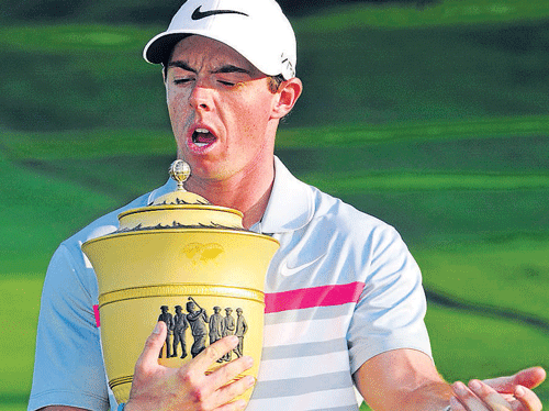Rory McIlroy poses with the trophy after winning the WGC-Invitational on Sunday. AP