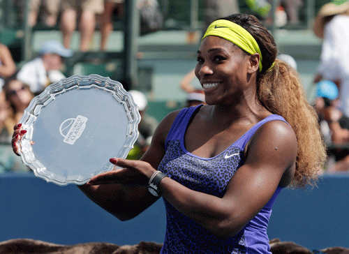Serena Williams holds the winner's trophy after beating Angelique Kerber, of Germany, during the championship match of the Bank of the West Classic tennis tournament on Sunday, Aug. 3, 2014, in Stanford, Calif. Williams won the match . AP Photo