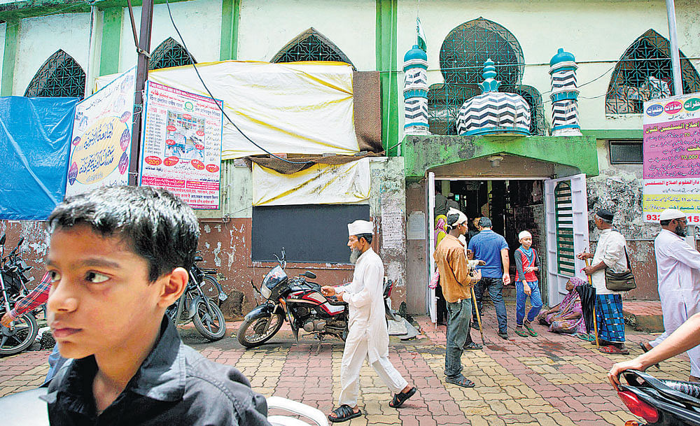 Muslim men left a mosque last month in Kalyan, India, on the outskirts of Mumbai. Four young men from the city were apparently recruited over the Internet to fight with Islamists in Iraq. NYT