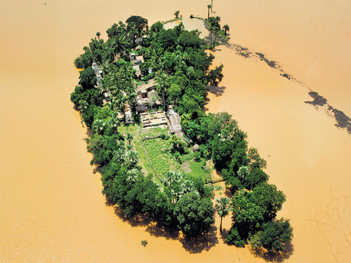An aerial view shows houses cut off by monsoon floods in the Kendrapara district of Odisha on Wednesday. AP