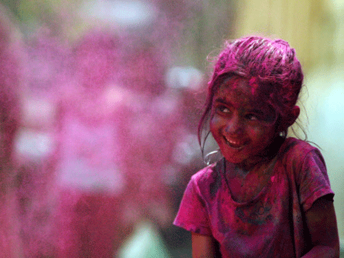 A girl, her face smeared with colored powder, participates in Holi celebrations in Chennai. AP file photo for representation purpose only