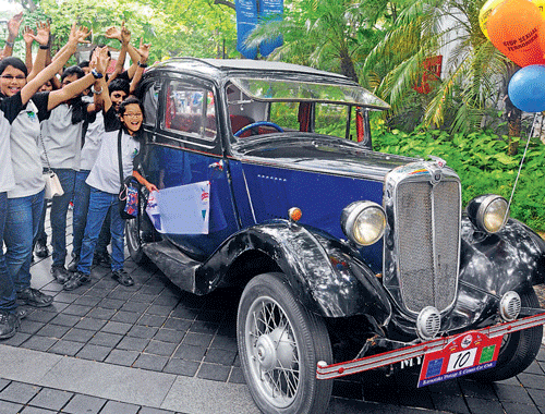 Children cheer at the annual Vintage and Classic Car Rally in Bangalore on Sunday. About 50 vintage cars participated in the event with the theme Respect and Safety for Women. DH PHOTO/ S K DINESH