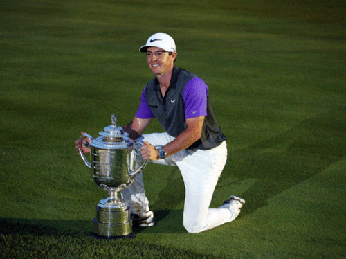 PGA golfer Rory McIlroy poses with the Wanamaker Trophy after winning the 2014 PGA Championship golf tournament at Valhalla Golf Club. Reuters photo