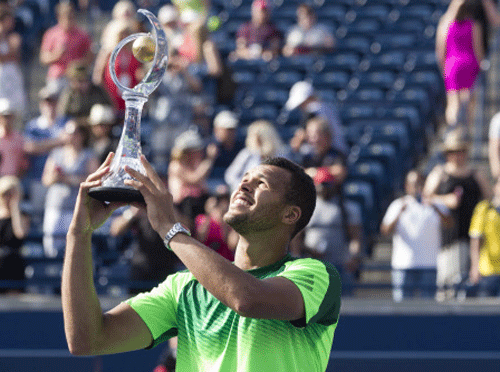 France's Jo-Wilfried Tsonga lifts the trophy after beating Switzerland's Roger Federer 7-5 7-6 to win the Men's Rogers Cup Singles final in Toronto on Sunday, Aug. 10, 2014. AP Photo