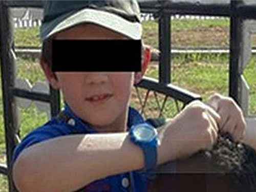 Australian Prime Minister Tony Abbott Monday voiced strong condemnation after an image emerged showing a boy, reportedly the son of an Australian ex-terror convict, holding a Syrian's severed head. Photo Courtesy: Twitter