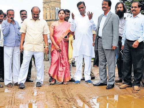 Revenue Minister V Sreenivas Prasad, accompanied by people's representatives and officials, inspects ongoing works in Mysore, on Tuesday. DH PHOTO