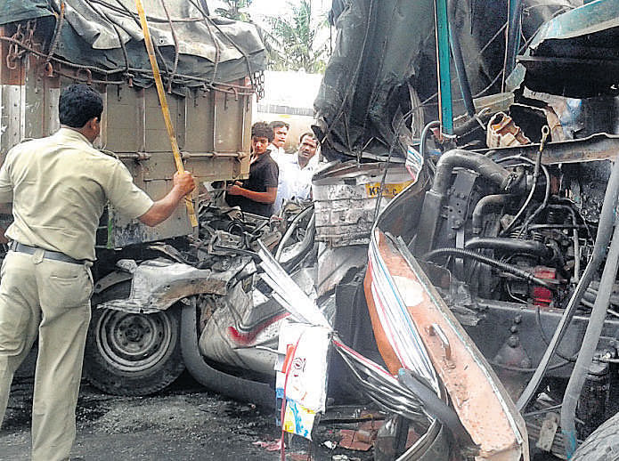 The mangled remains of the vehicles that were involved in a serial accident near Veerasandra industrial estate on Hosur Road on Tuesday. One person was killed and four others injured in a pile-up involving a mini goods vehicle, a van, four cars and two bikes. DH photo