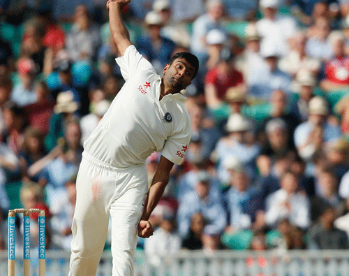 India's Ravichandran Ashwin bowls to England's Joe Root during the second day of the fifth test cricket match at Oval cricket ground in London, Saturday, Aug. 16, 2014. (AP Photo