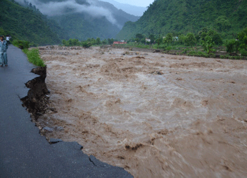 : Damaged roads by overflowing Saung river at Tehri Garhwal area near Dehradun on Saturday. PTI Photo