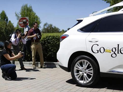 Members of the media take photos of a Google self-driving vehicle at the Computer History Museum after a presentation in Mountain View. Reuters file photo
