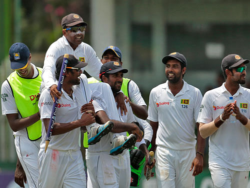 Sri Lankan players carry their teammate Mahela Jayawardene, who played his final test, after they won their second test cricket match against Pakistan in Colombo, Sri Lanka, Monday, Aug. 18, 2014. Jayawardene ended his illustrious 17 year test career in near perfect style in the whitewash win for Sri Lanka against Pakistan on Monday. AP Photo