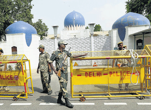 : Securirty personnel guard the entrance of the Pakistan High Commission in New Delhi on Tuesday  during a protest against Kashmiri separatist leaders.  PTI photo