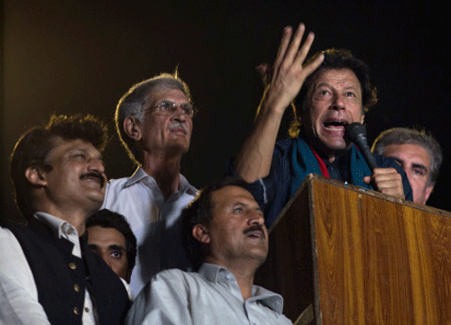 Pakistan's cricketer-turned-politician Imran Khan delivers a speech to his supporters urging them to march to Parliament in Islamabad, Pakistan, Tuesday, Aug. 19, 2014. AP photo
