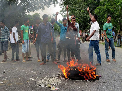 A police man was injured and a police vehicle and three trucks were set ablaze in Assam's violence-hit Golaghat district today by a mob that blockaded NH 37 protesting against the police action at Rangajan. PTI photo