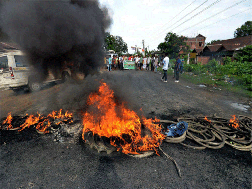 Police fired in the air and burst tear gas shells to disperse protestors trying to block NH 39 at Numalimargh in trouble-torn Golaghat district this morning in defiance of the indefinite curfew even as the army staged a flag march to maintain law and order. PTI photo