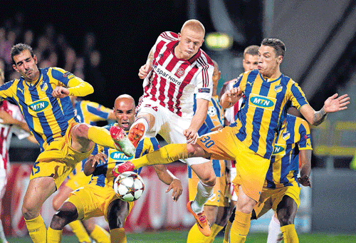 Won't let you go! Aab Aalborg of Denmark's Thelander (centre) fights for the ball with APOEL Nicosia's Antoniades and De Vincenti (right) during their Champions League play-off match at the Nordjyske Arena in Aalborg on Wednesday. REUTERS
