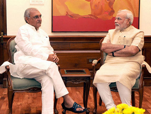 Prime Minister Narendra Modi with Chief Minister of Haryana, Bhupinder Singh Hooda at a meeting in New Delhi on Friday. PTI Photo