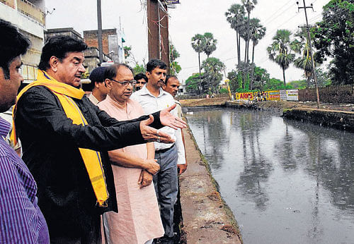 BJP parliamentarian Shatrughan Sinha inspects a water drain system at Saidpur in Patna on Friday. PTI  photo